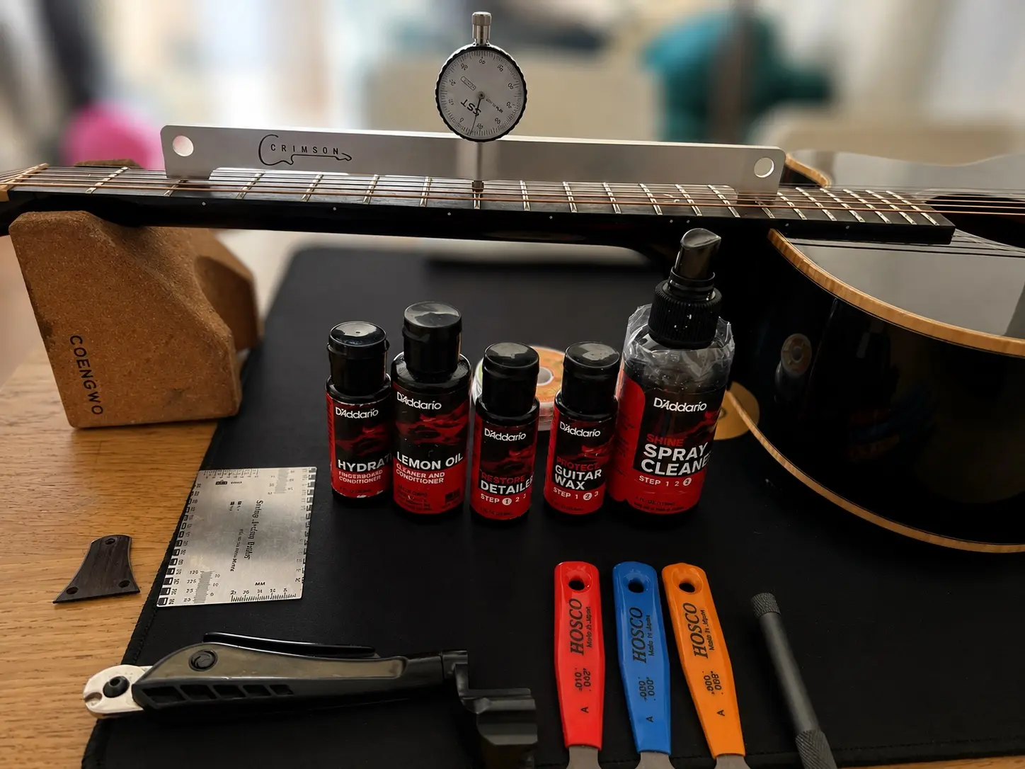 Dial gauge measuring neck relief on an acoustic guitar in Nottingham