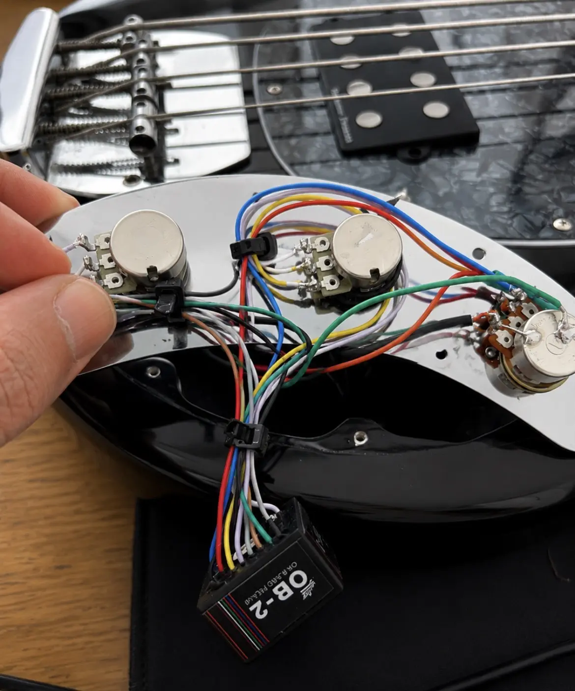 Bass guitar control plate and wiring during an electronics repair in Nottingham