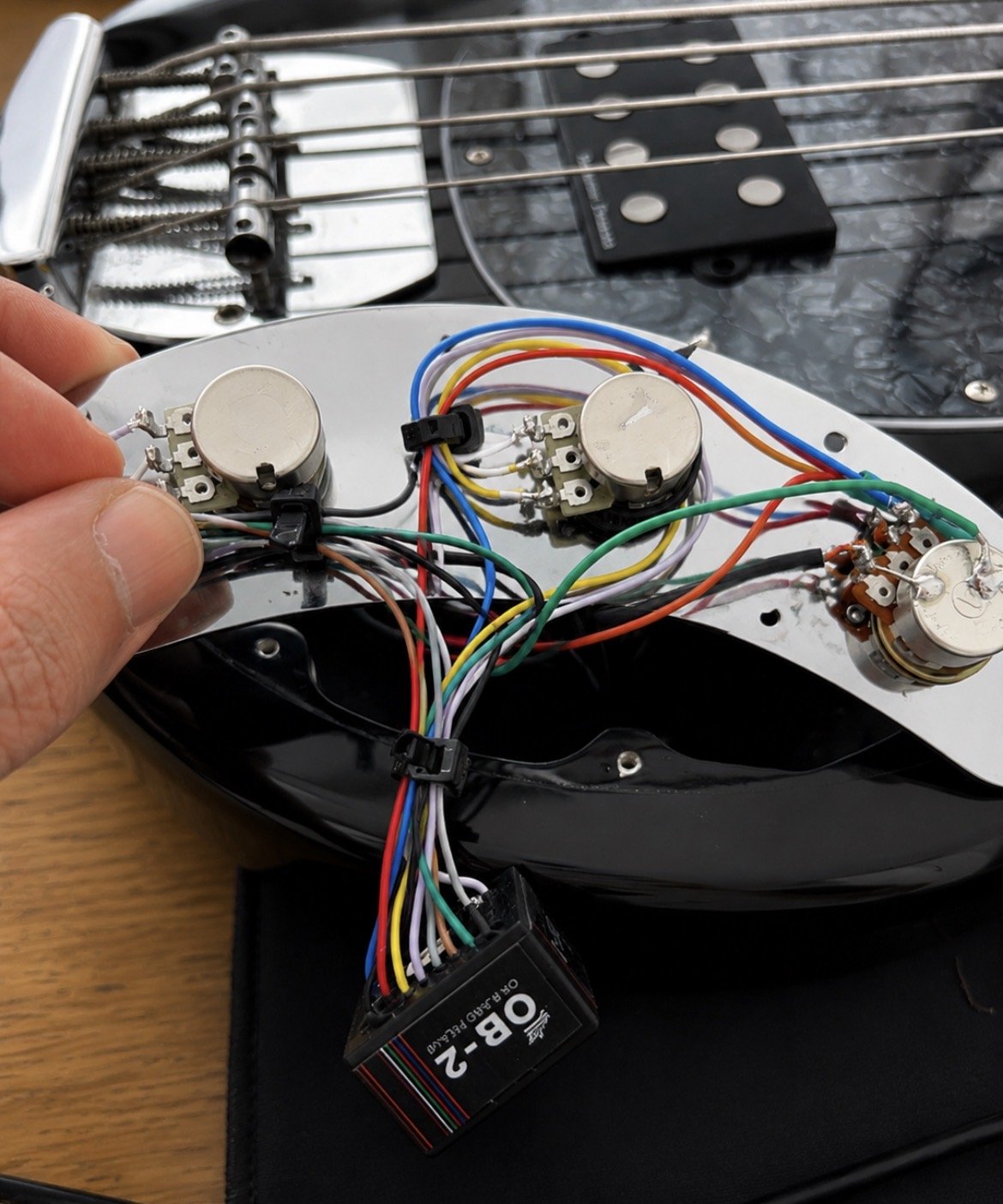 Bass guitar control plate and electronics during a professional rewire in Nottingham