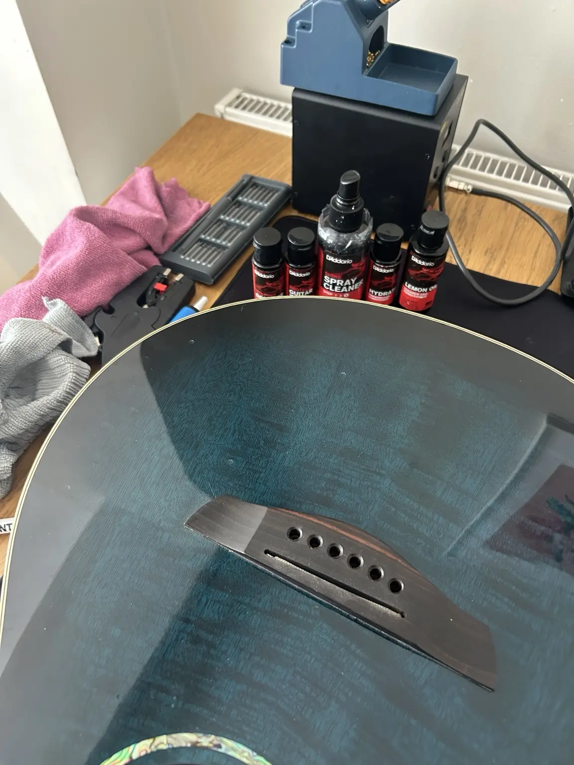 Blue acoustic guitar receiving a professional clean and setup in Nottingham