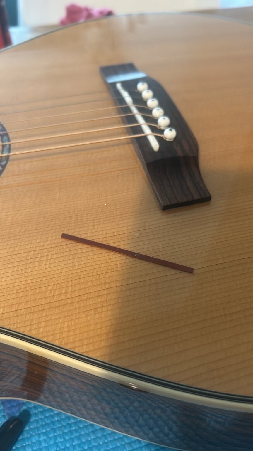 Custom carbon fibre acoustic guitar saddle shim
