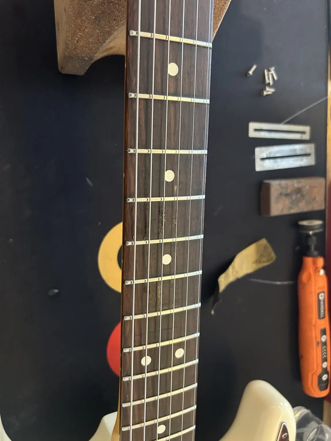 Close-up of electric guitar frets during professional fret dressing