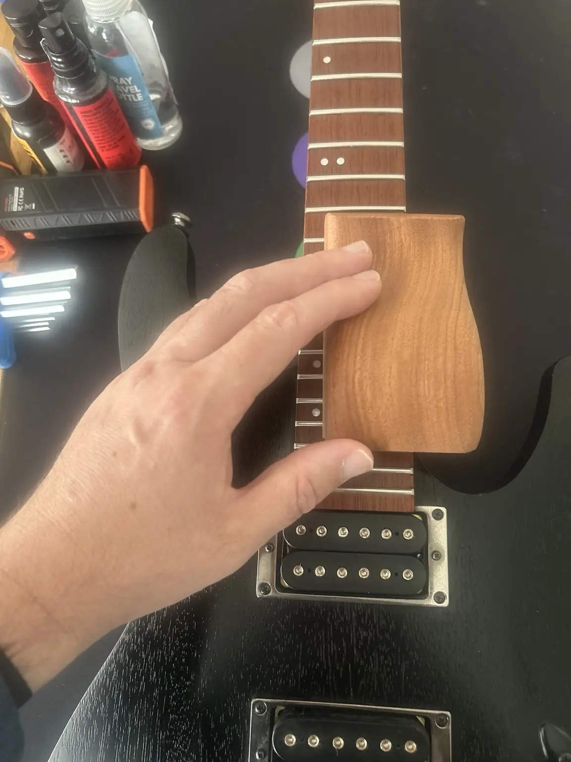 Electric guitar fretwork being checked with a precision fret tool