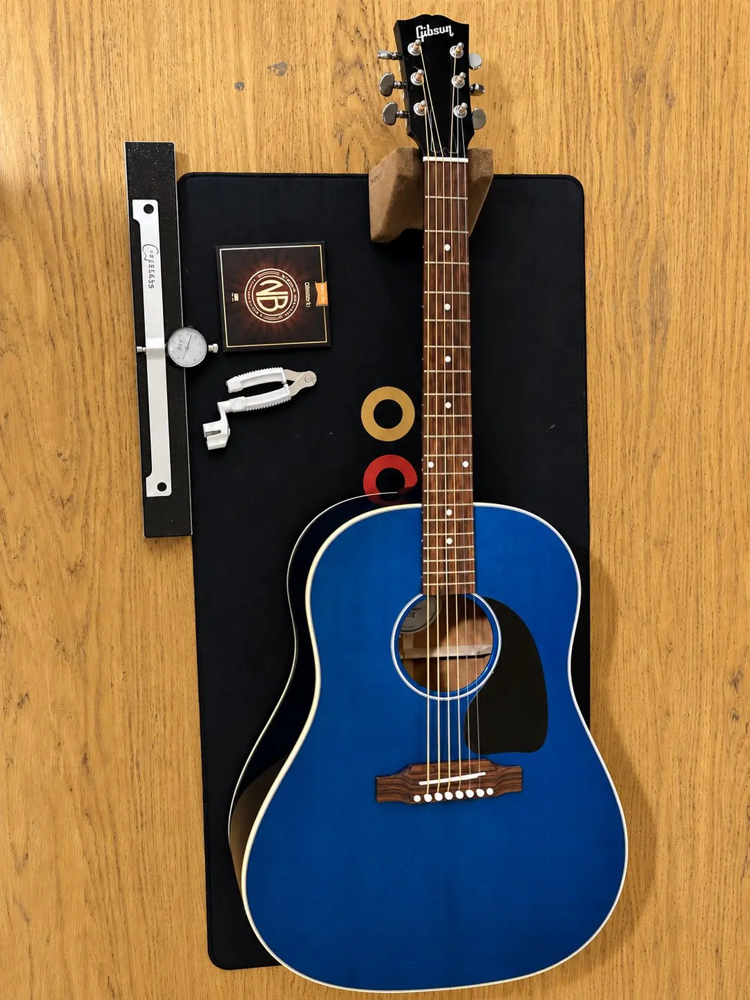 Blue Gibson acoustic guitar undergoing a professional setup in Nottingham