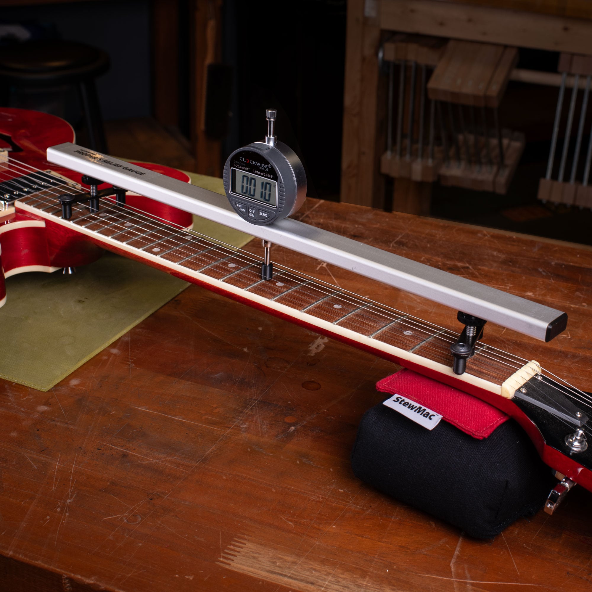 Proper’s Relief Gauge measuring a guitar neck for a precision setup in Nottingham