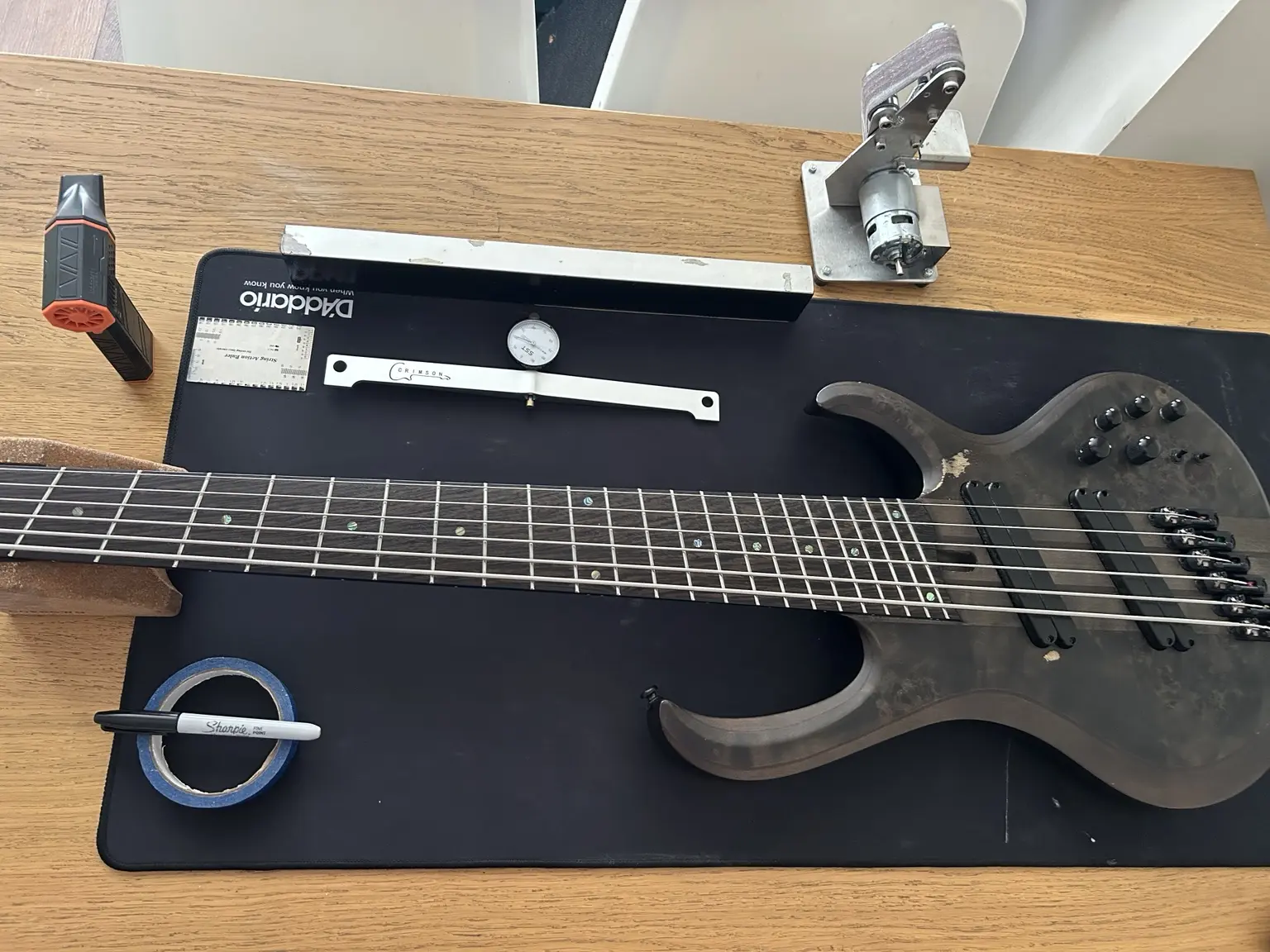 Seven-string bass guitar prepared for a precision setup in Nottingham