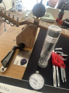 Hosco TL-NF10 guitar nut file set with a digital dial indicator and setup tools